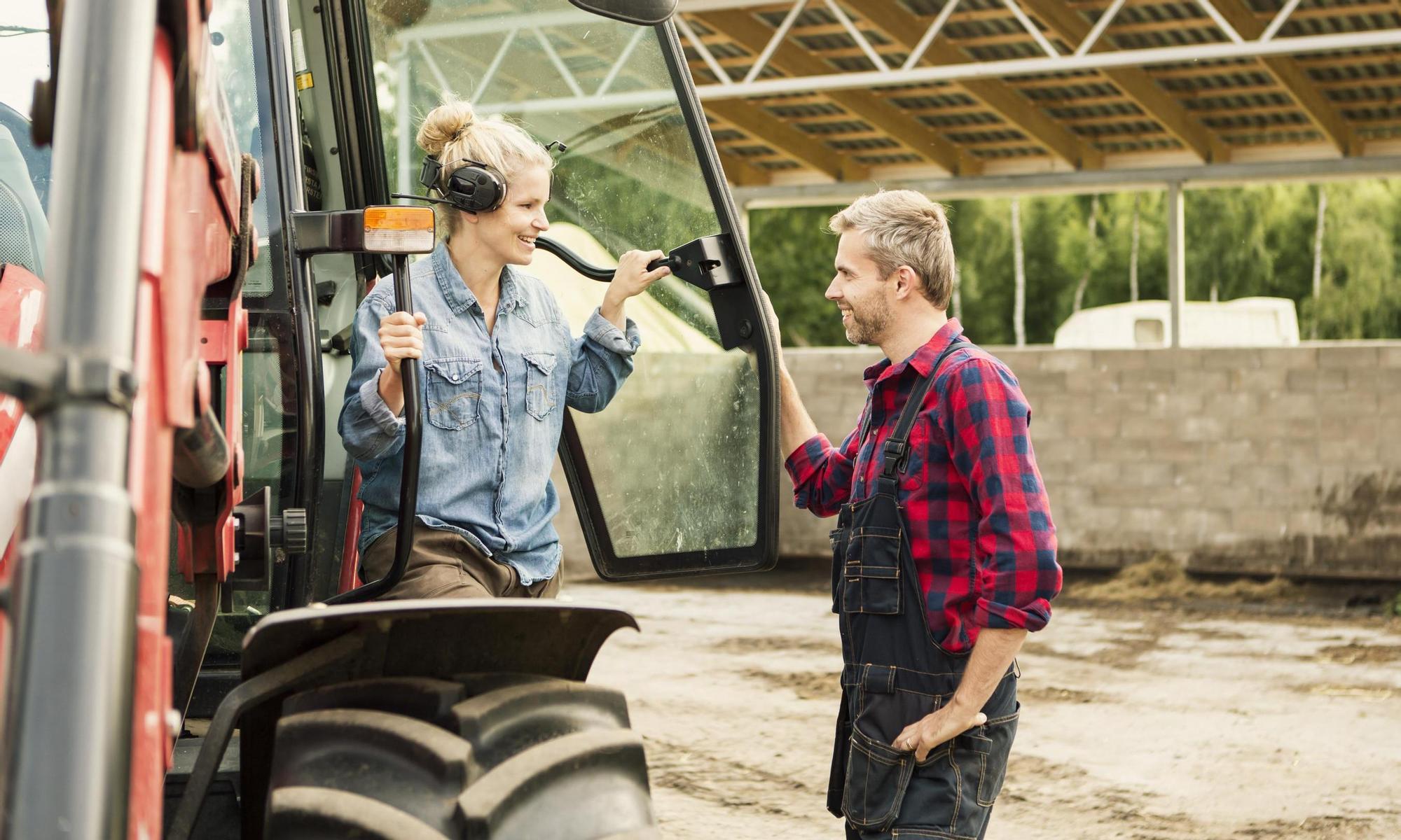 A farmer couple by their tractor